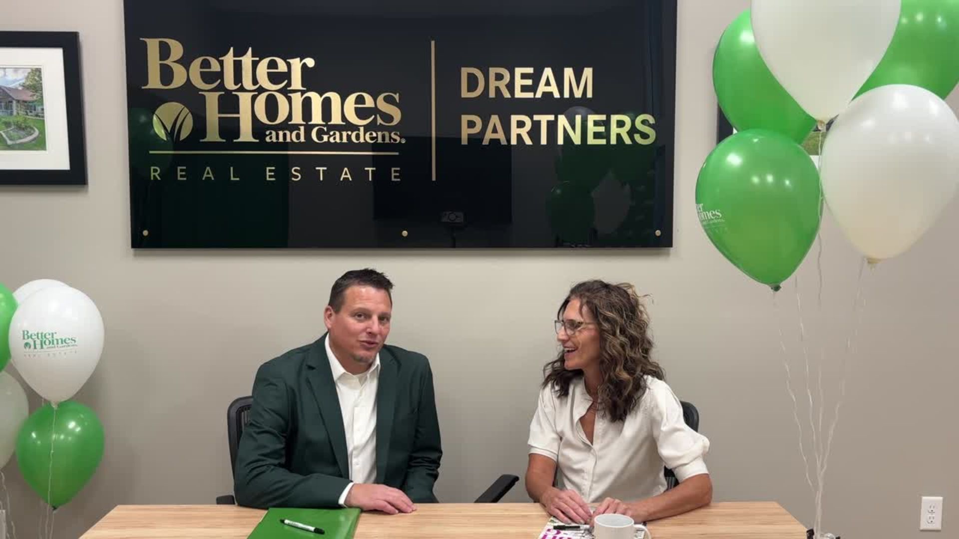 Kevin and Renee at home office sharing BHGRE Announcement